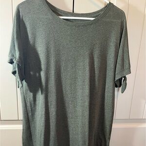 Women’s green top with ties on sleeves.